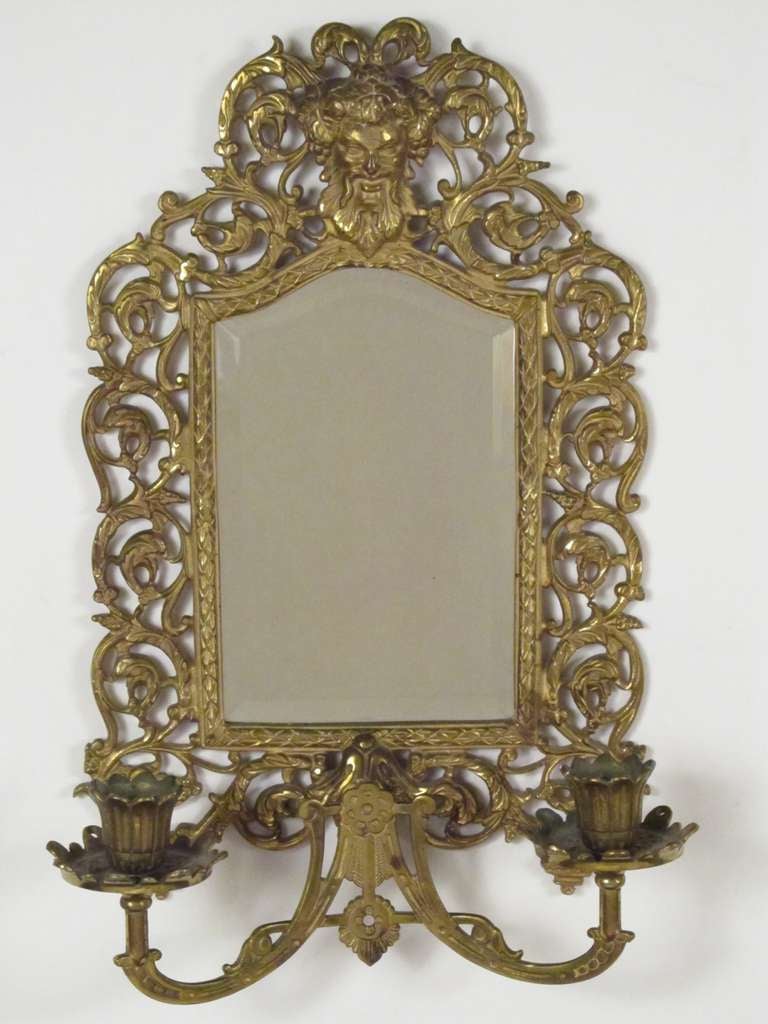 Made of solid brass, with original bevelled glass mirror and a tin backing. At the very top is Bacchus, smiling at you, with grape leaves and grapes in his hair. Each bobesh has perforations, suggesting that there may have been hanging crystals at
