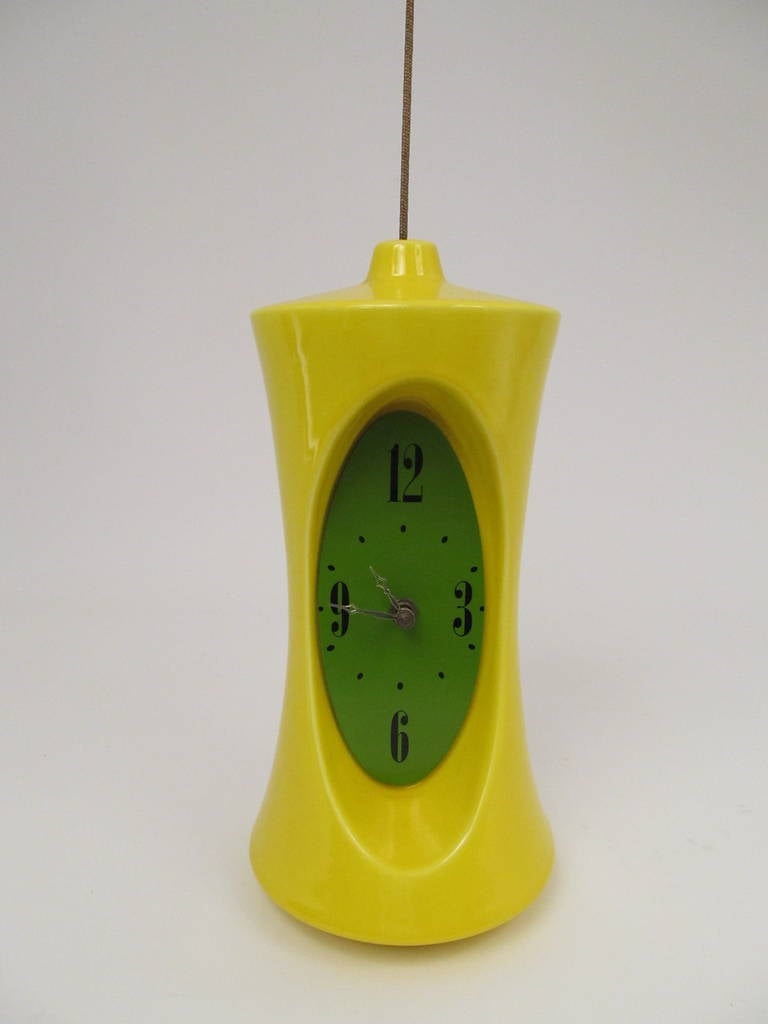 This terrific time piece certainly encapsulates the wackiness and creativity of the 1970s. Bright optic yellow so it really pops! Excellent condition, and works. Original label from Vohann of California, and design credit to Charles Chaney. Includes