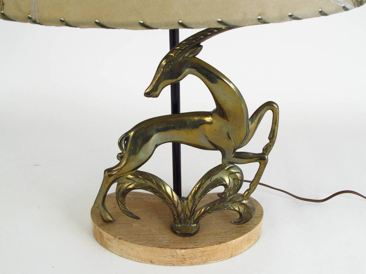 A dramatic and graceful figural gazelle, mounted in a free-form kidney shaped blonde serused oak base.