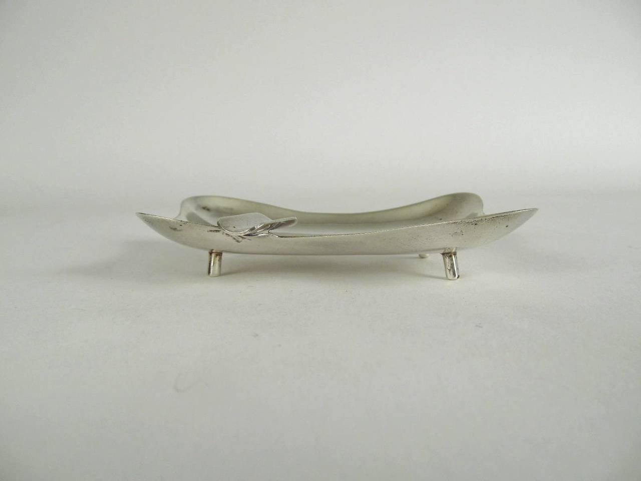 A very nice sterling ashtray done in the free-form or biomorphic style of the late 1940s and 1950s. It's four lobed and stands on four feet. And comes with a felt presentation bag from Sanborns department store in Mexico City.