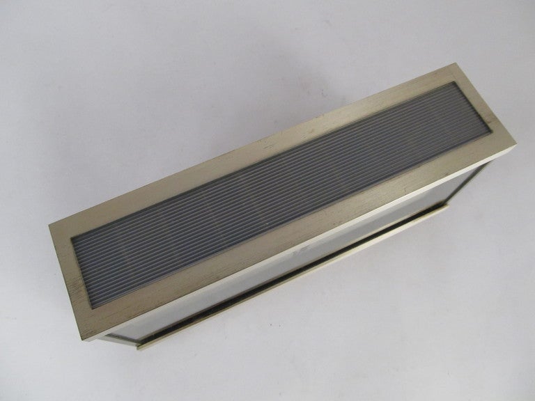 An executive looking desk clock from the 1960's.  Brushed stainless steel case made in Germany.  Has a working solar panel on the top of the case that would have been used to charge a rechargeable cell.  Works well on standard C cell battery.