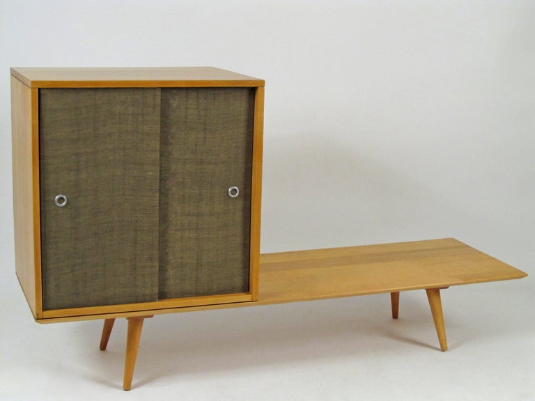 Part of the Planner Group from the 1950s, made by Winchendon Furniture, this is a modular pairing of a low platform and a 2 door cabinet, with one fixed shelf.