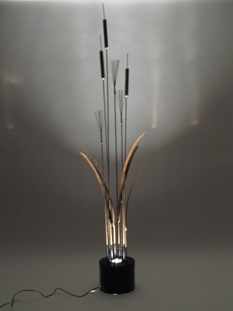 Standing 6 feet 8 inches tall, this is a piece that makes a statement.  Each strand is separate and can be arranged as desired.  It's illuminated from the base.  