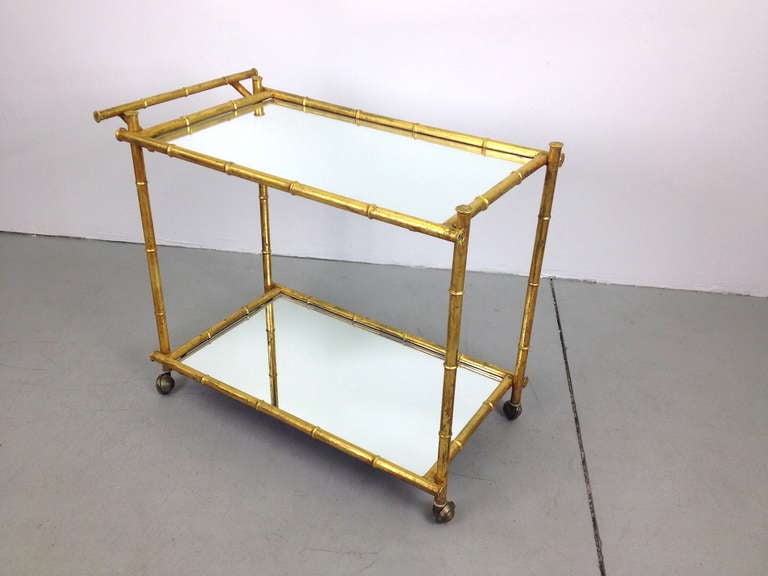 Gilt Metal Faux Bamboo Serving Cart with Mirrorted Glass Shelves.  Very nice condition.  Brand new mirrored glass shelves.