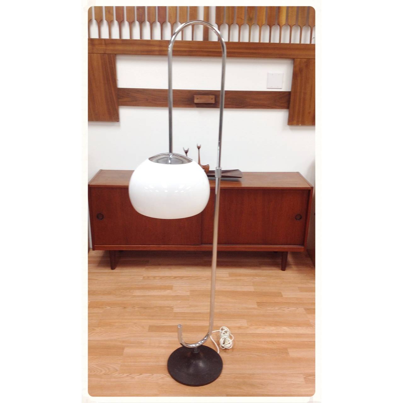 Adjustable chrome floor lamp by Reggiani. Lamp height and position are adjustable.