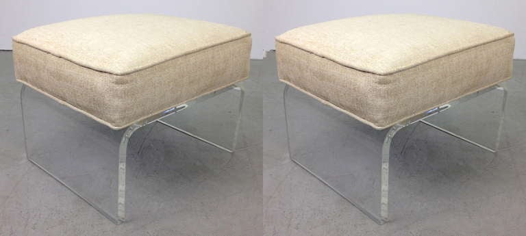 Pair of lucite footstool stools or ottomans.  Very nice condition with new upholstery.  Price is for the pair.