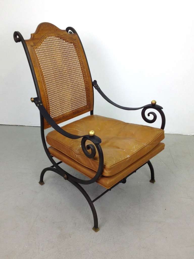 Elegant iron wood brass leather and wicker lounge chair.