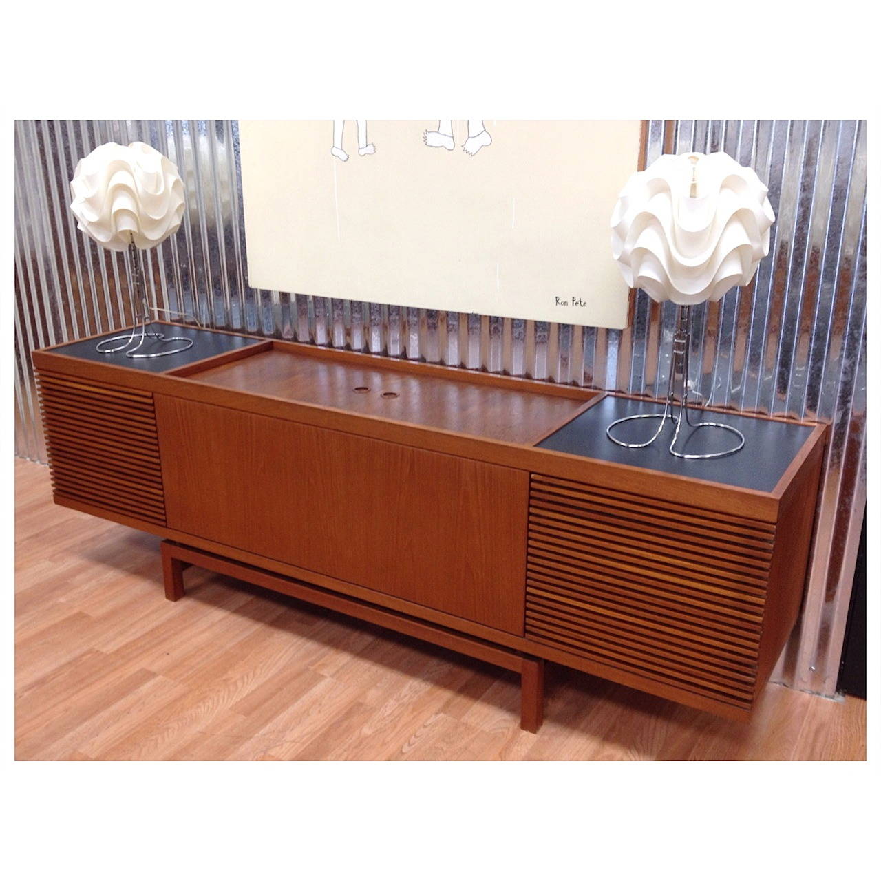 Vintage Danish modern teak stereo media cabinet credenza made in Denmark. Great looking cabinet with removable slatted teak speaker grills. Two sliding doors on top reveal a spacious storage area for your components with an adjustable shelf with