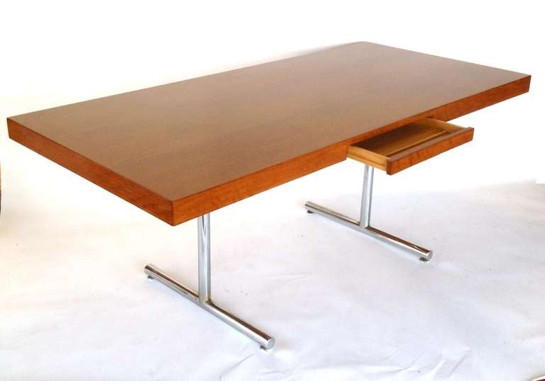Omega Desk by Hans Eichenberger for Haussmann & Haussmann Distributed by Stendig.  Oak Top professionally refinished in a medium Teak Color.  Chrome legs have a patina from age.  Marked with 3 Stendig Labels.  