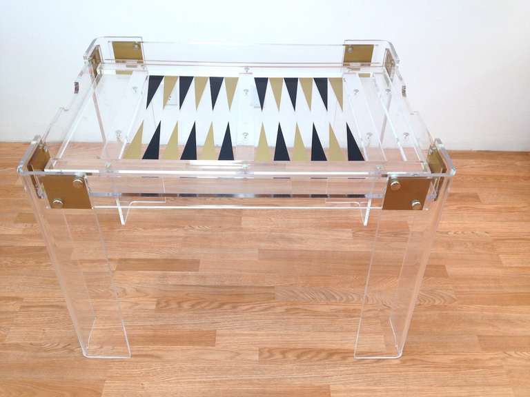 Vintage Lucite and Brass Backgammon Game Table.  Very nice original condition with a scratch on the underside as pictured in the last image.  Glass Top is included but is not pictured.