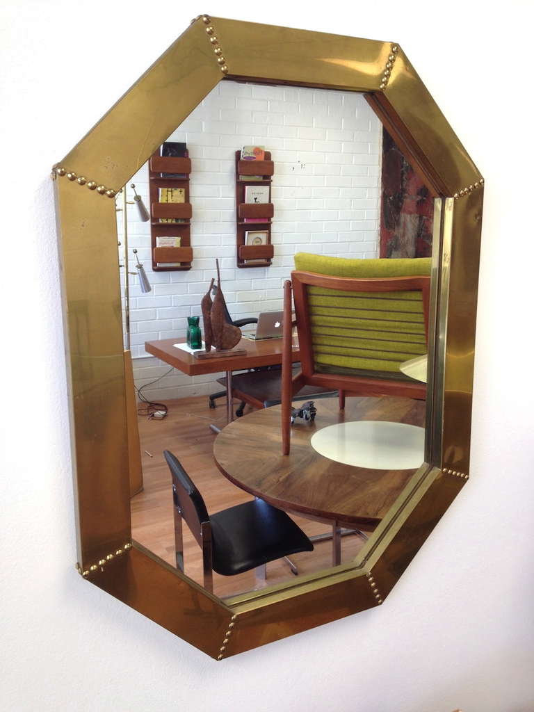 Brass Clad Octagonal Mirror by Sarreid.  Original condition with a ding and some minor wear as pictured.  Marked Made in Spain on the back side.