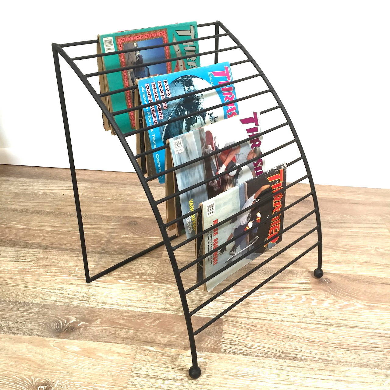 Mid-Century iron magazine or newspaper rack. Smart and practical storage and display for the daily paper as well as your favorite magazines.