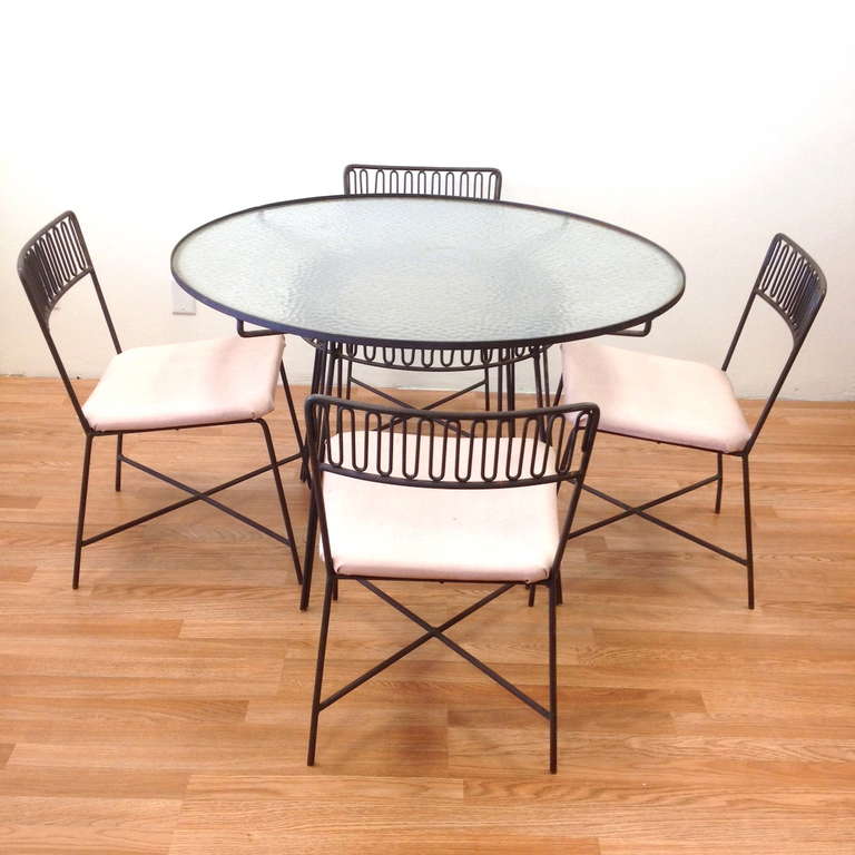 Mid Century Iron patio Set Attributed to Salterini.  Seats should be reupholstrered to match your decor.  Table measures 29