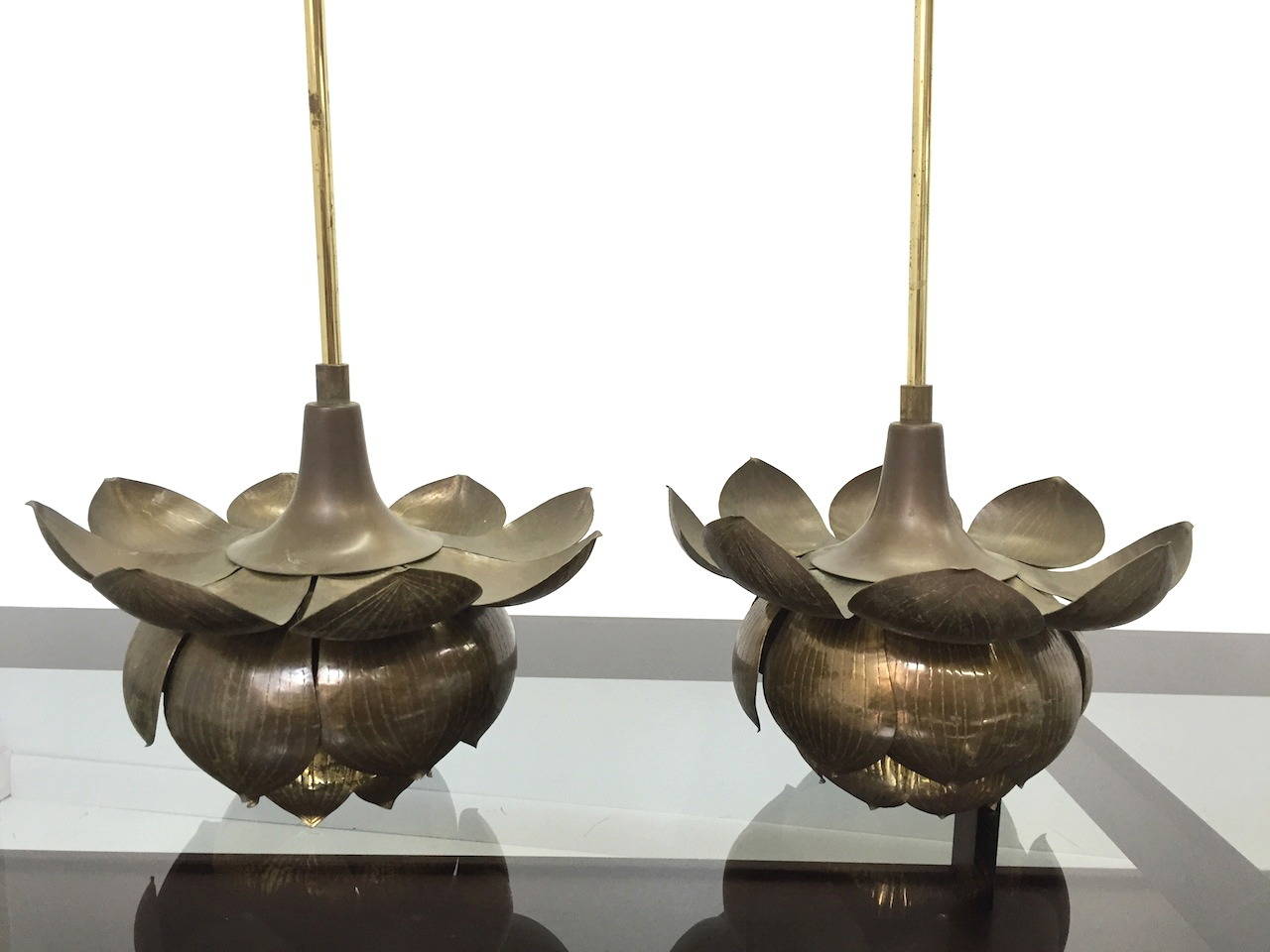 Pair of Vintage Brass Lotus Pendant Lights by Feldman.  Nice original condition with a desirable patina from age.  These are currently fitted with long brass tubes for the wiring which can be re-used, shortened, or replaced with a chain depending on