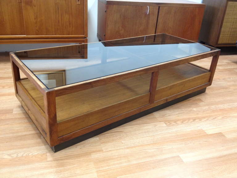 Danish Modern Walnut and Smoked Glass Coffee Table with Storage by Glenn.  Very nice condition with some light scratches to glass top from use.  Marked with early Glenn label inside drawer.