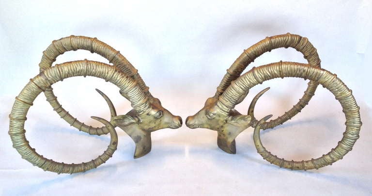 Exceptional Pair of Brass Rams Head Gazelle Ibex Dining Table Bases.  Large and very nicely cast.  Expected patina from age - these have not been cleaned or polished.  Can accommodate a large piece of glass (approx. 4' x 8')  Bases only - No Glass