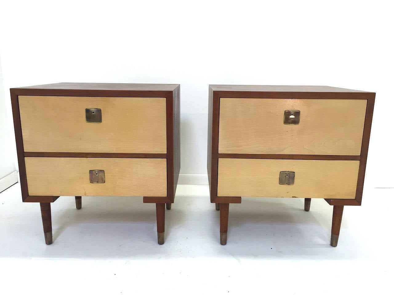 Pair of Paul Frankl nightstands for Johnson Furniture Company. These are missing the brass handles and have some minor wear from use as pictured. They are being sold in as found condition for restoration. Matching chest of drawers and Hi Boy dresser