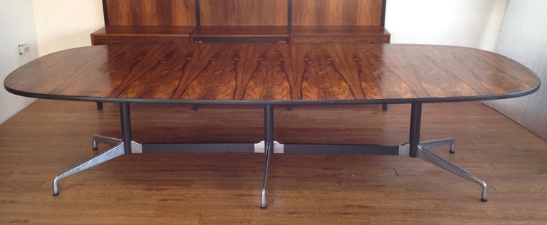10 Foot Long Herman Miller Aluminum Group Rosewood Conference Table by Charles Eames.  Wonderful rosewood grains.  This table is in used condition with some light surface scratches and some minor chipping along the edge as detailed in the pictures.