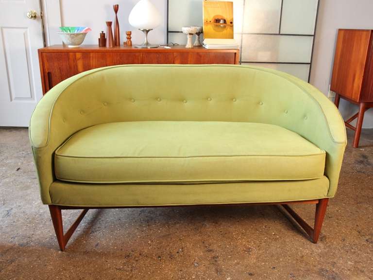 Petite loveseat with elegant Danish modern lines. Sculptural teak frame, button back, piping. This little sofa is wonderful as-is, but with new fabric it will really shine; ask us about our upholstery services. 1960s.

52