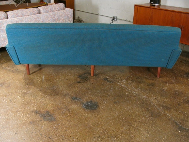 Lovely teal-blue fabric covers this impeccably styled tight-back sofa. Tapered teak legs. Fabric has very subtle houndstooth effect. Made in Denmark in the 1960s. Please see our listing for the matching chair.

Dimensions: 88