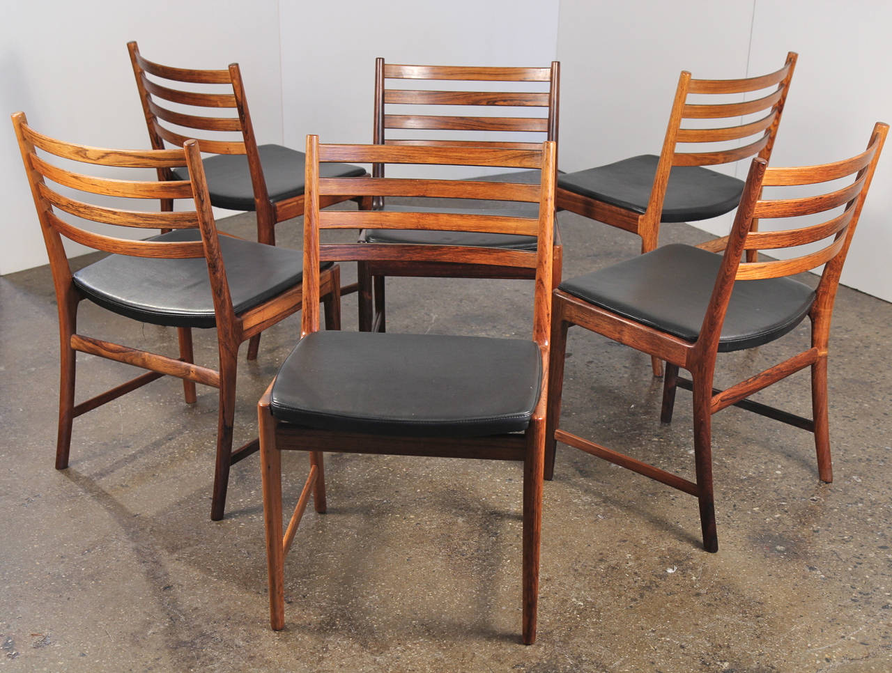 Set of six Danish modern dining chairs feature ladder backs and leather seats. These chairs are stylish, comfortable, and finely crafted. In excellent vintage condition. Attributed to Ole Wanscher. Denmark, 1960s.

19