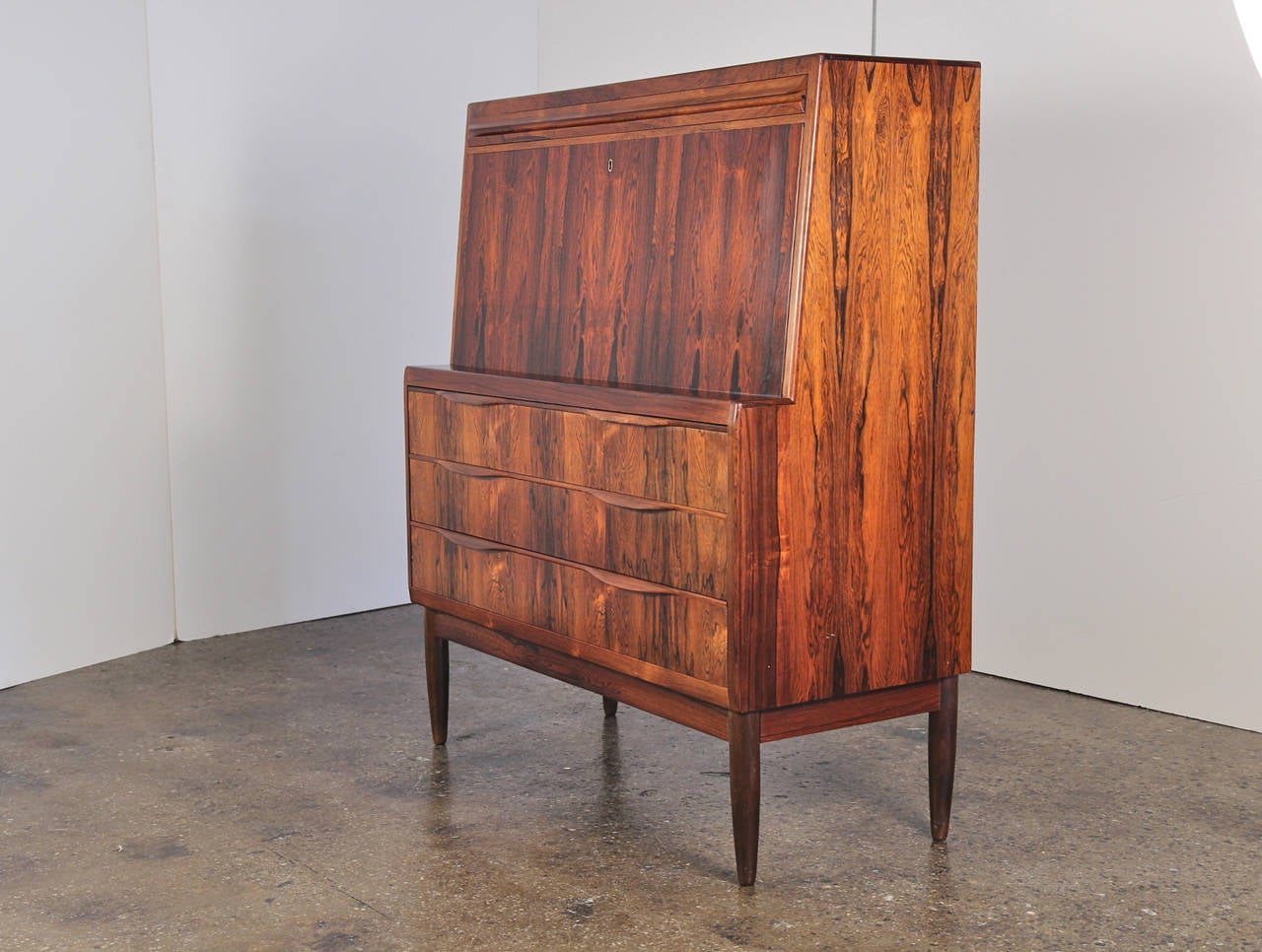 Stunning writing cabinet! Flip down the desk to reveal drawers, storage cubbies, and more. Masterful cabinetry details on this Danish modern piece designed by Ib Kofod-Larsen. This piece is equally at home in the office, living room, or bedroom as a