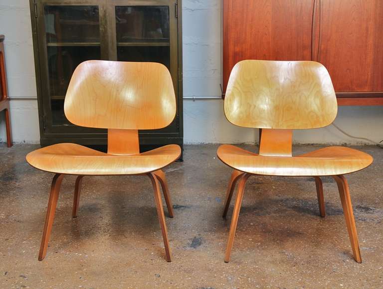 Iconic lounge chairs designed by Charles and Ray Eames. Made of molded ash plywood, the wood grain has a striking pattern. Original screws. Shock mounts in good original condition. No stamp but marked 