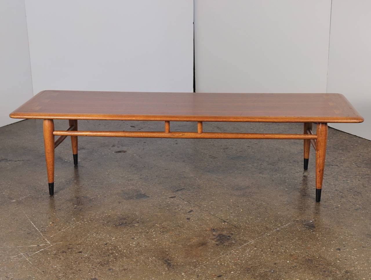 This mid-century coffee table shows off the craftsmanship of its dovetail joints with contrasting tones of wood. At around four-and-a-half feet long, it's the perfect size for the city apartment. In excellent vintage condition. Made by Lane.