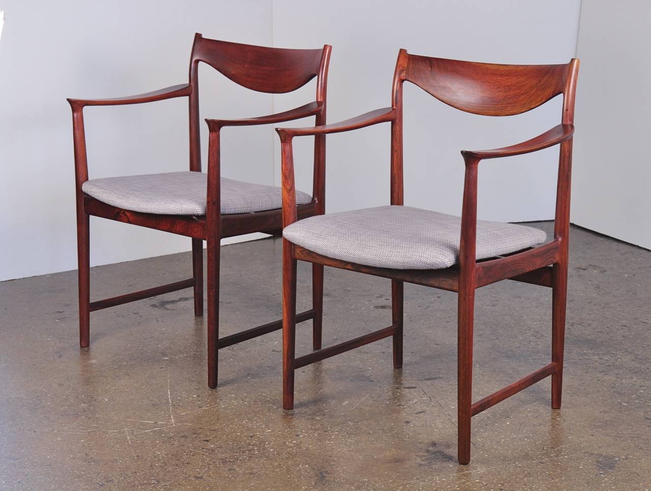 Stunning pair of chairs in rich Danish rosewood. We love the curvaceous, sculptural frames. Newly upholstered in a neutral Holly Hunt fabric. Use at the dining table or as occasional chairs. Made in Denmark. 1960s.

22