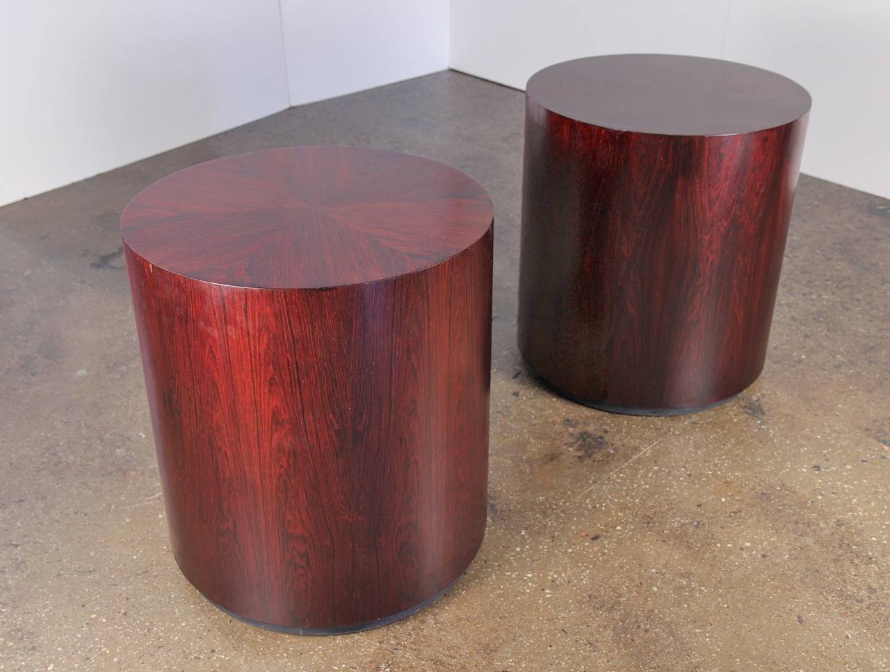 Rosewood occasional tables designed by Harvey Probber. These sleek mid-century tables are so versatile. Rich, gleaming rosewood displays beautiful grain. Hidden casters allow for easy movement. Tables bear the Probber label. 1960s. In excellent