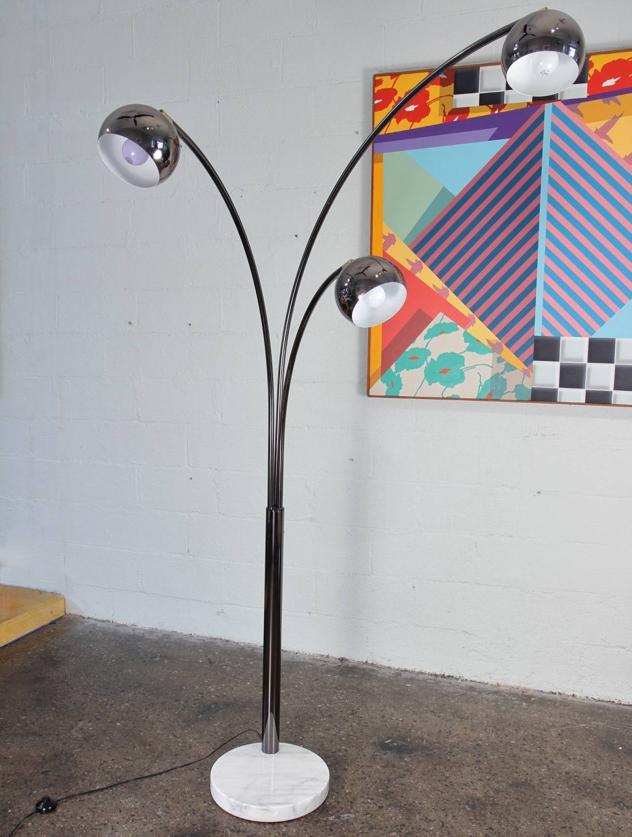 A massive three-globe arc lamp with marble base designed by Goffredo Reggiani. This Italian modern floor lamp has an elegant smoked chrome finish that's a bit subtler than polished chrome. The globe shades are movable. There's a foot switch and a