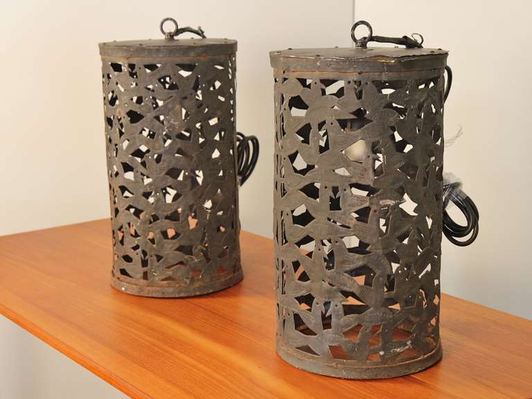 We've never seen anything quite like these handcrafted outdoor light fixtures. At first, the design seems abstract; then suddenly you see all the birds! We think these primitive metal lanterns would look great hanging in a garden, or try them over a