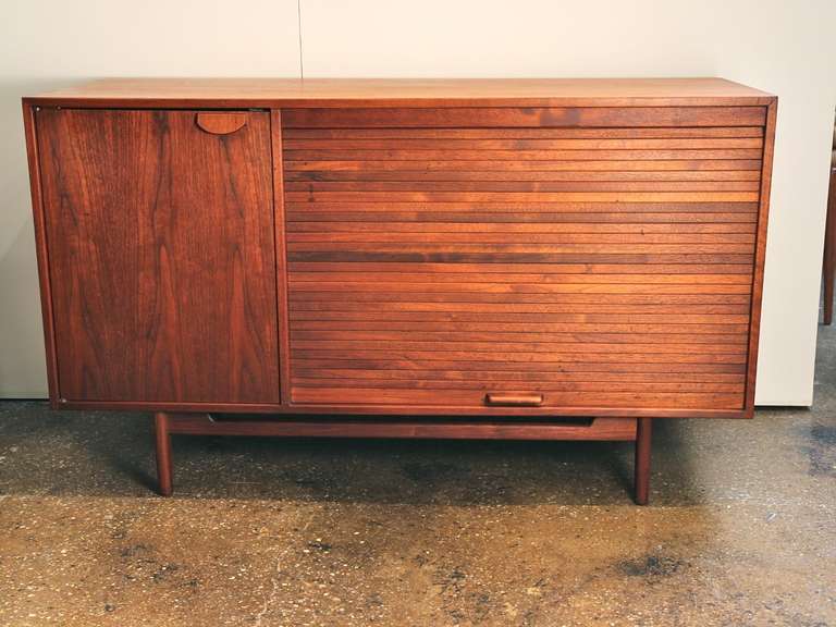 A highly functional tambour door and adjustable shelves make this sideboard a dream for storage in the living room, dining room, or office. The tambour door rolls up out of the way, and stays up, until you pull it down. A floating base gives this