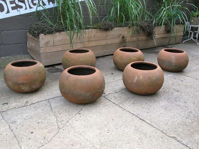 Incredible set of six handcrafted earthenware planters. Each pot is unique and has a wonderful weathered patina. These would look stunning as a grouping in a mid-century patio or inside the home. Pots have drainage holes. Made in Mexico,