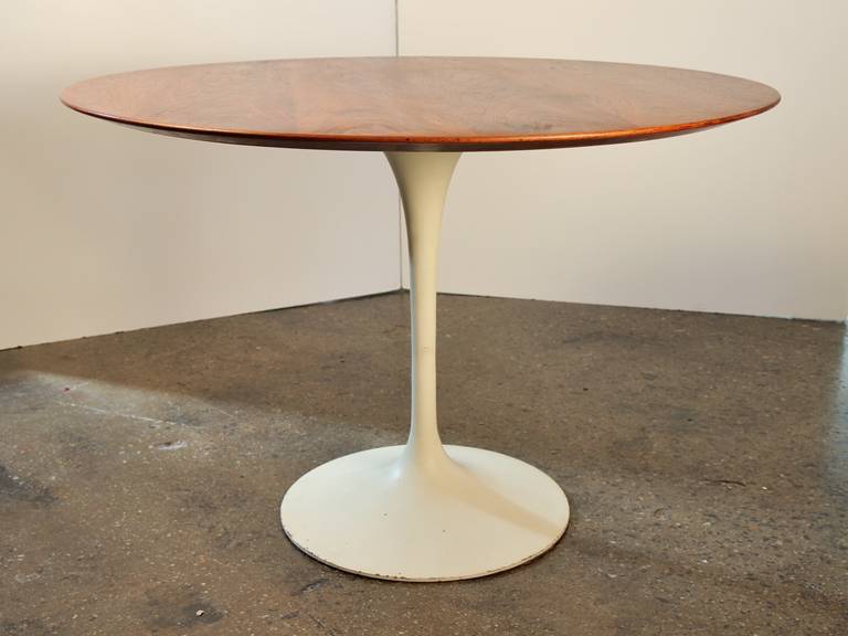 Fully restored. The walnut top of this dining table from Saarinen's Pedestal Collection for Knoll has a wonderful patina and a rich glow. Solid hardwood construction, unlike the composite used in newer models. In excellent vintage condition; base