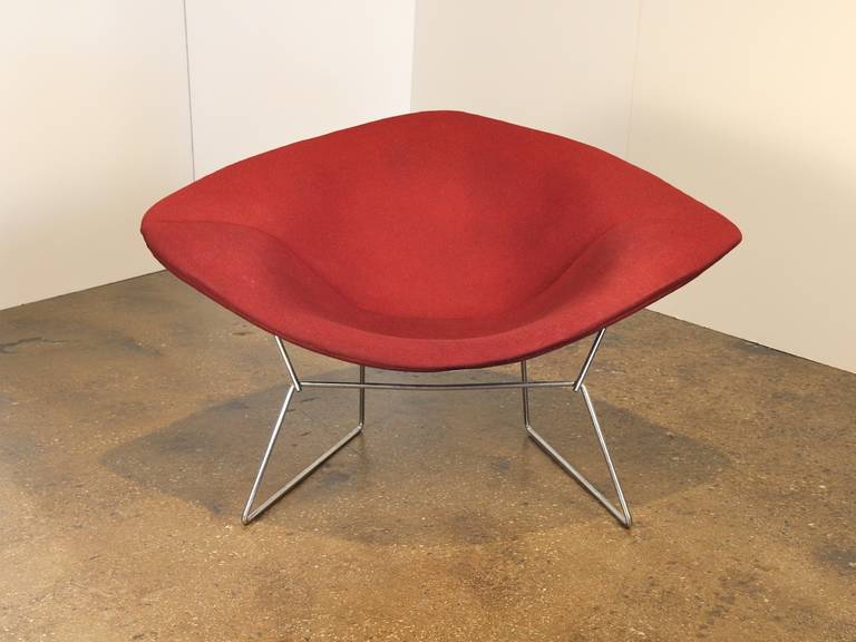Vintage large diamond chair designed by Harry Bertoia for Knoll in 1952. The chair has its original full fabric cover which retains the Knoll label. The color is a burgundy red. The chromed steel is in excellent condition; the cover has a small hole