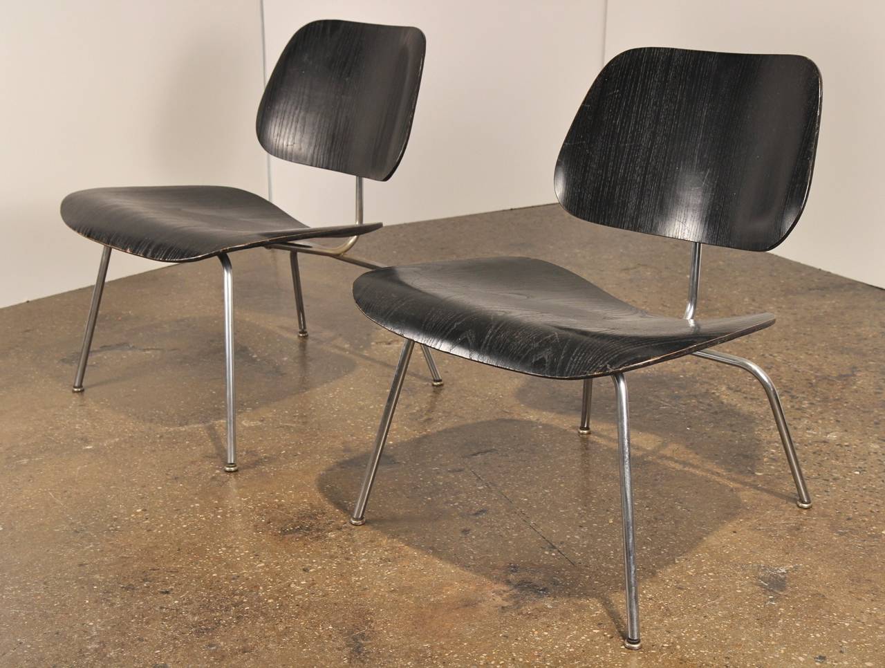 A vintage pair of ebonized lounge chair metal designed by Charles and Ray Eames for Herman Miller in the 1940s. These lovely chairs date to the 1950s and are in excellent condition. The plywood has a beautiful patina and the shockmounts are in good