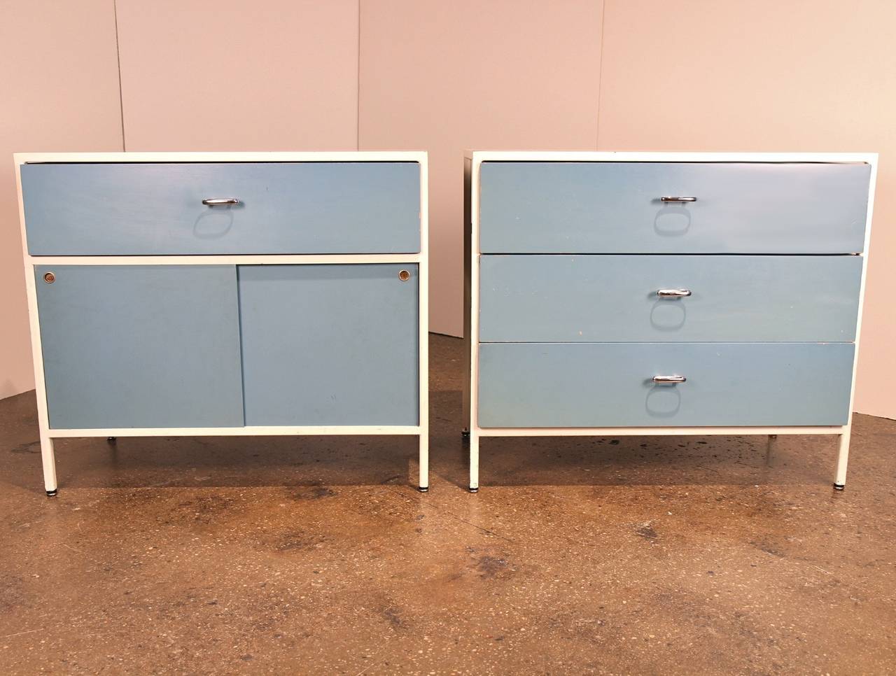 We offer this rare pair of cabinets designed by George Nelson for Herman Miller in 1954 and dating to the late 1950s or early 1960s. 

A minimalist philosophy inspired Nelson's design: steel frames offer visual interest, while also eliminating the