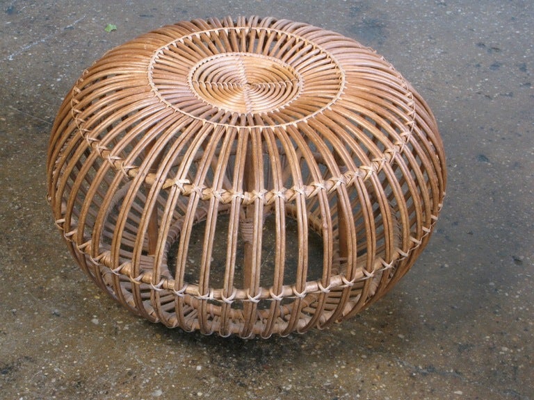 Large Albini ottoman in excellent condition (one loop of rattan has come a bit loose). Beautiful original woven rattan—the artful weaving and structure of the ottoman is a design feat. Spherical shape is perfect as a footrest or a light-duty side