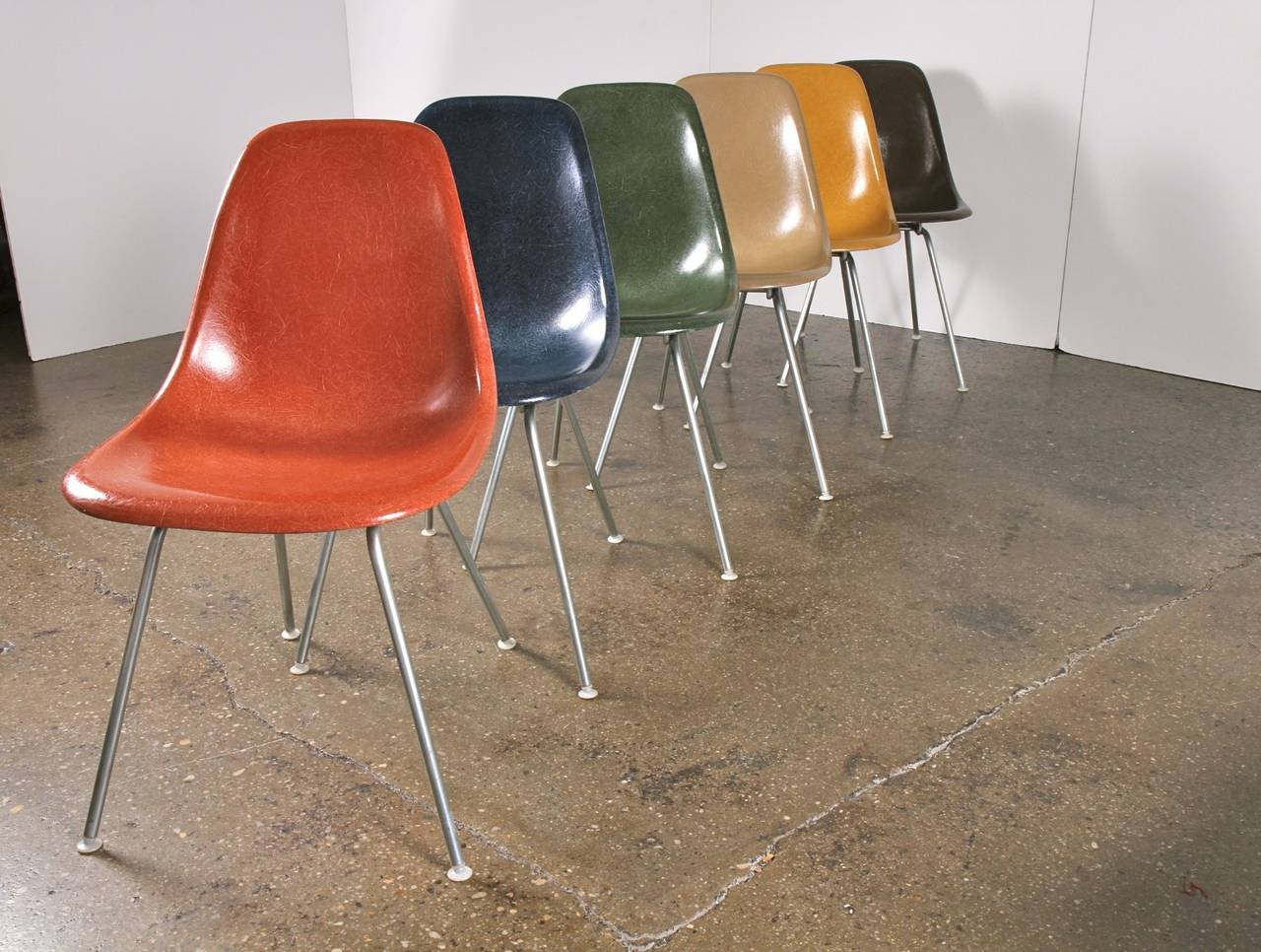 Vintage 1960s molded fiberglass side shell chairs designed by Charles and Ray Eames for Herman Miller. Gleaming shells are in original condition, each with a distinct thready texture. We have many colorways in stock, including Ochre Light Yellow,