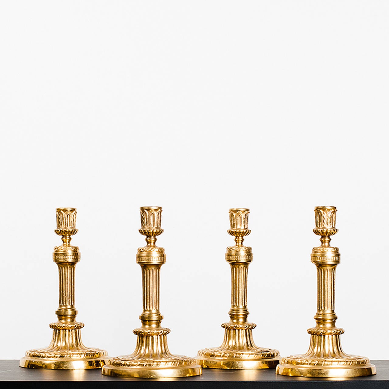 Set of four gilt bronze candlesticks Louis XVI style .France 20 th c.