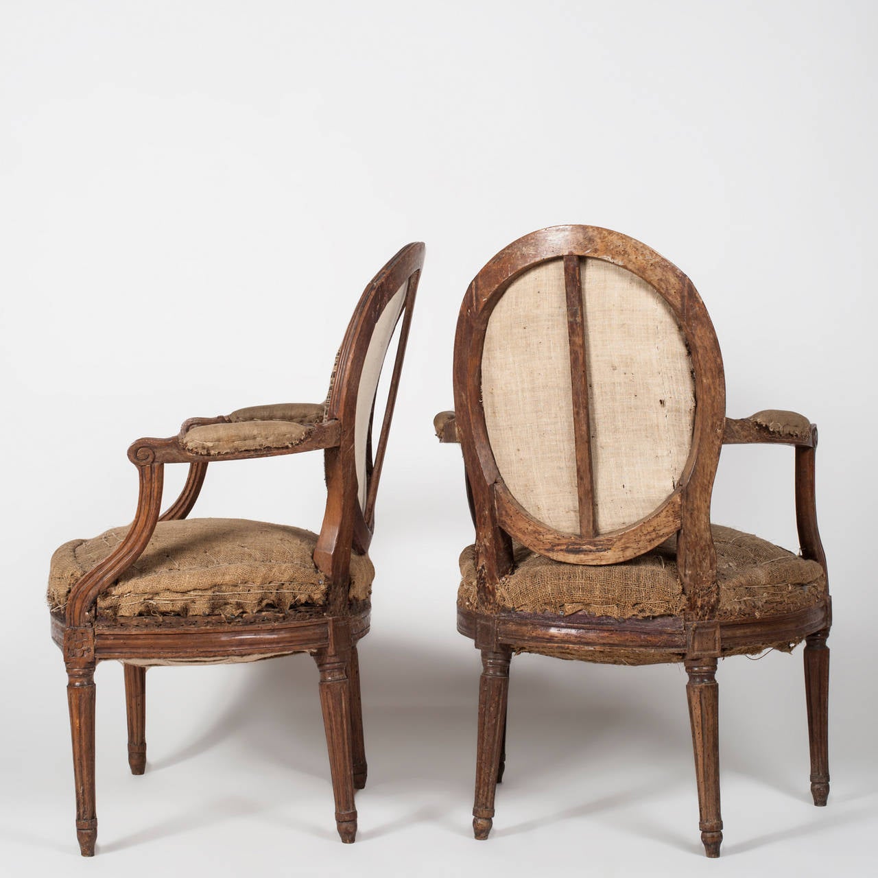 Very old French Louis XVI armchairs fauteuils without upholstery.
In these photos the chairs appear in his original conditions.  

