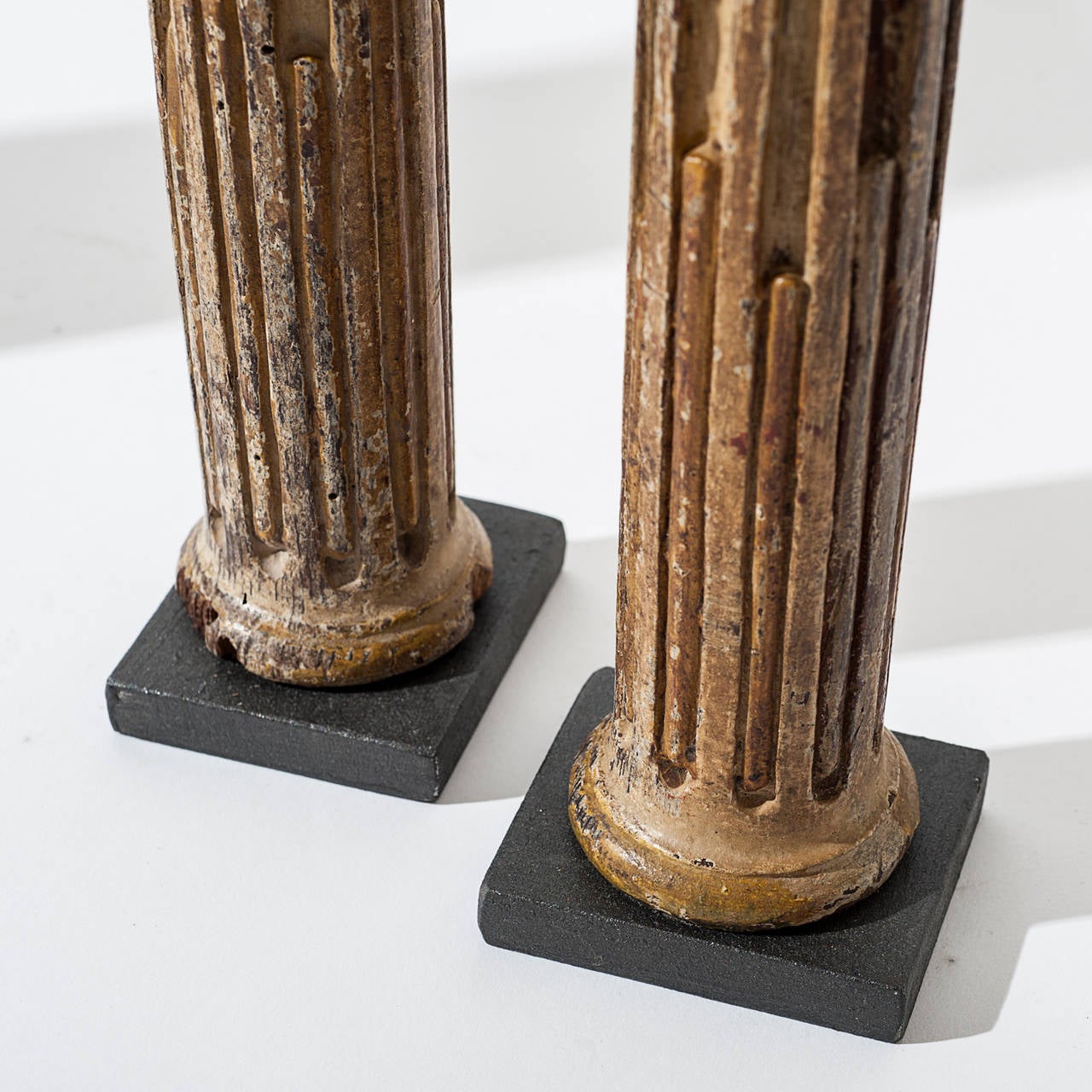Four small Doric columns, made of painted wood on a base of black stone, retains some of its original colors. 17th century Spain