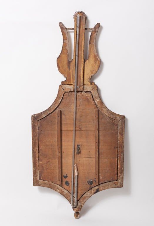 Barometer end of the 18th century,Directorie,  in carved and gilded wood, by Selon Toriceli, with allegory music wing on the top, beautiful patina, and decorative barometer with mechanism, but is not in working order.