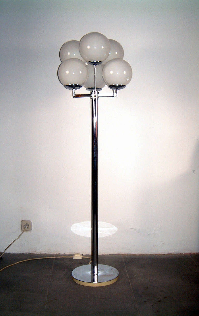 metal chromed floor lamp with six glass globes.