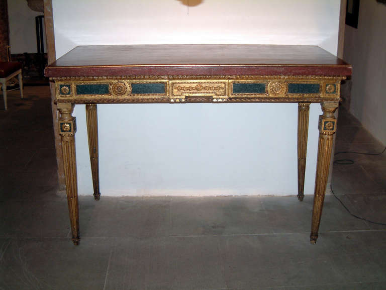 Carved, polychromed and giltwood console table.
Faux porphyre wood top.