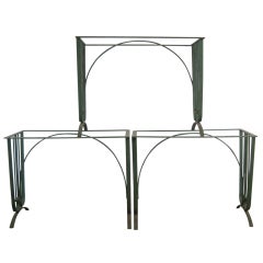 A set of five iron garden tables