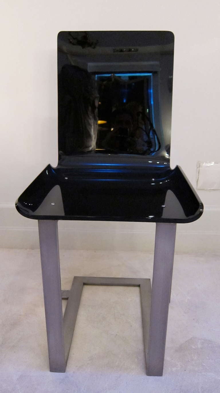 A pair of chairs in black lucite and steel by Marc du Plantier. Lacloche edition. Paris 1960.