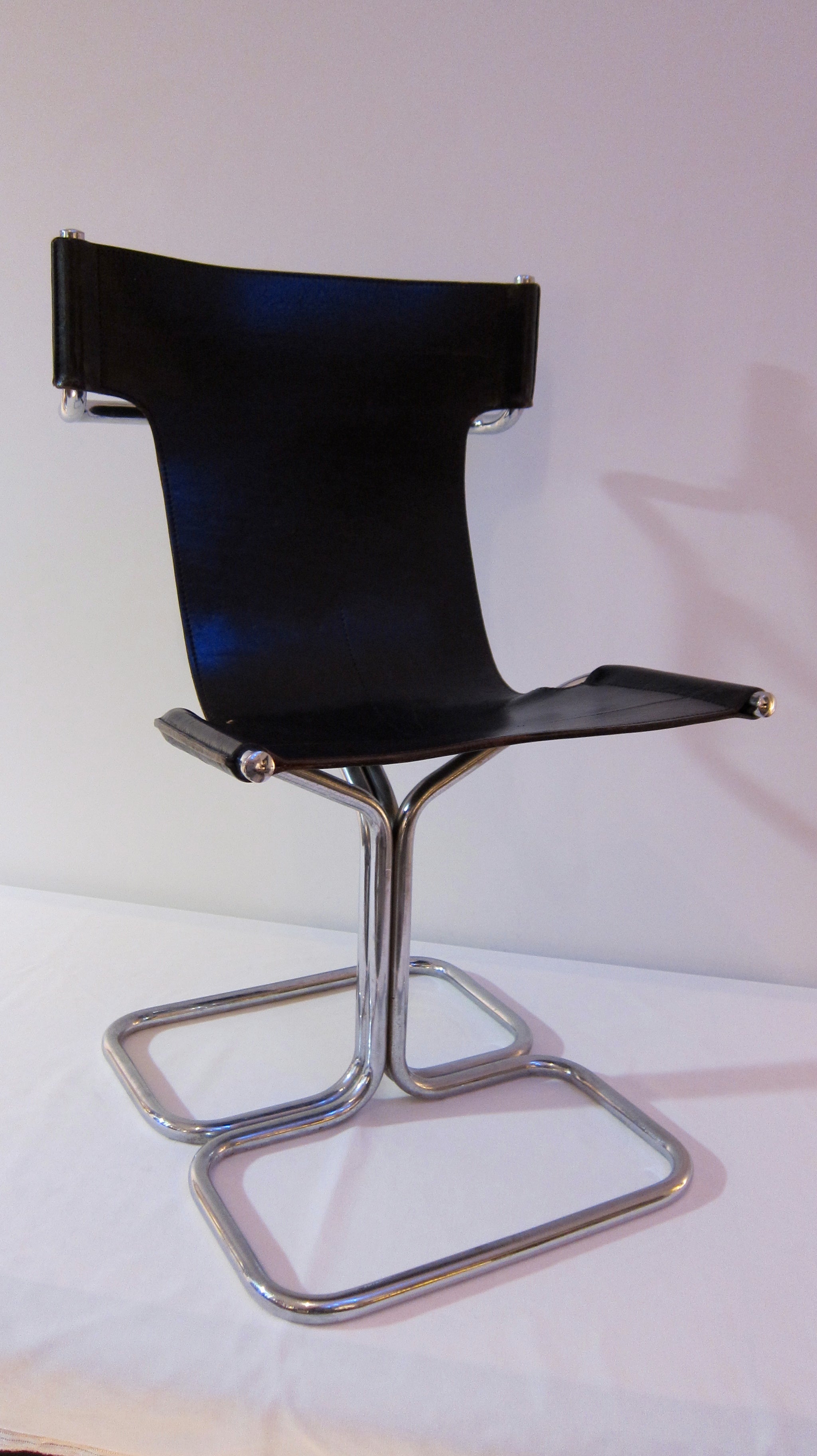 Set Of Four Tubular Chromed Steel And Black Leather Chairs. For Sale