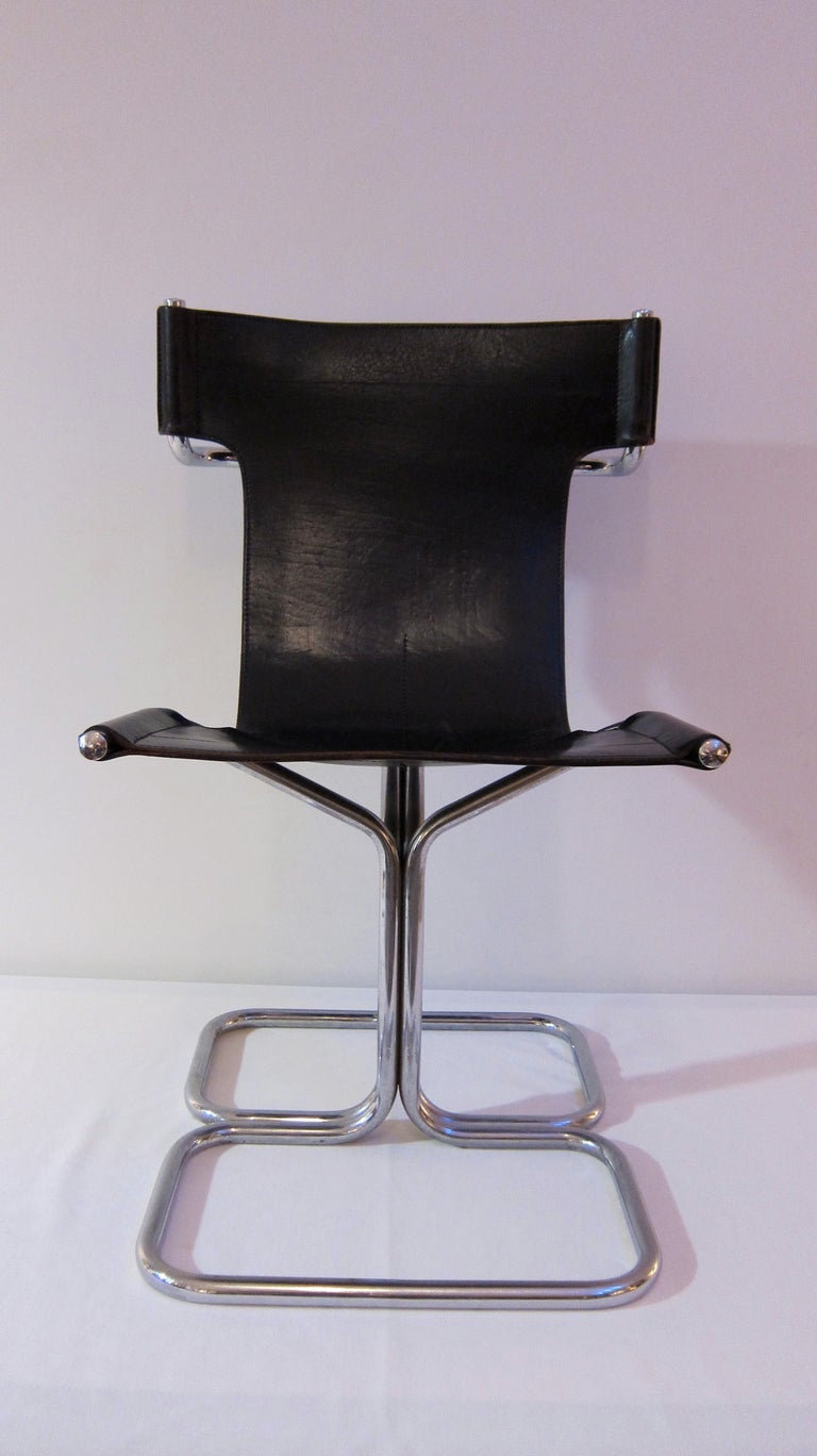 Set of four tubular chromed steel and black leather chairs. France 1960